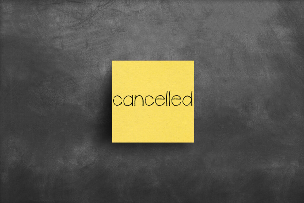 Yellow post-it note with the word cancelled on it indicating a cancelled project