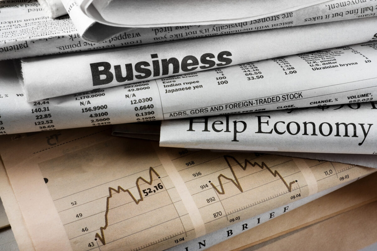 Business newspapers and charts depicting economic uncertainty