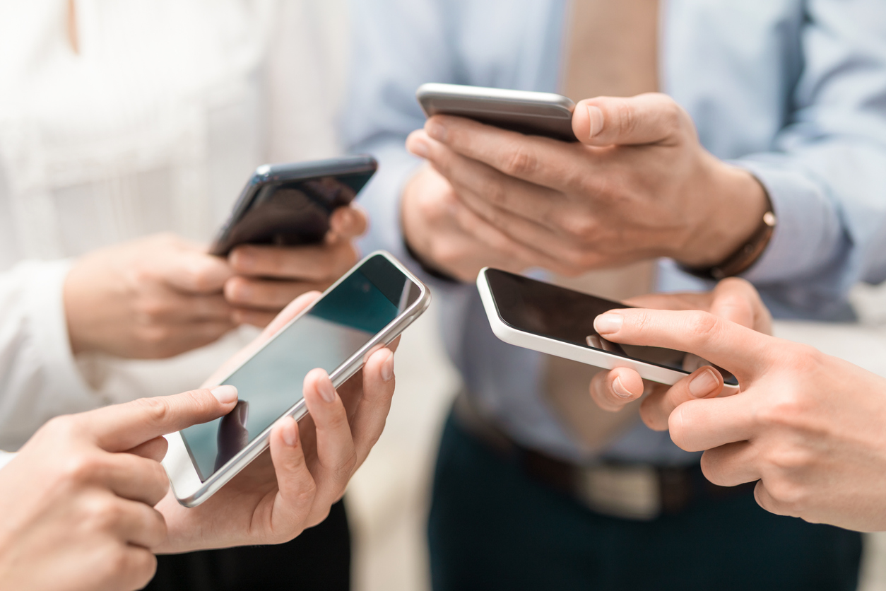 Group of business people using their smartphones