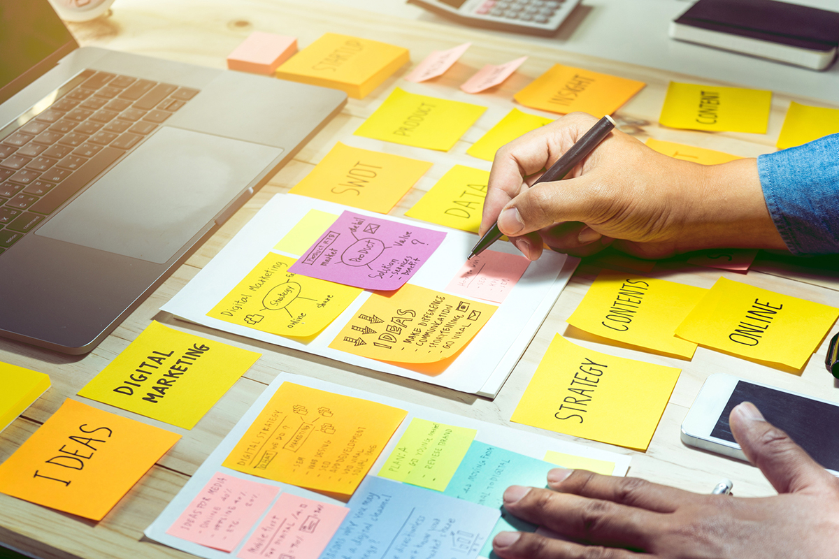 Person using post-it notes to develop a content strategy
