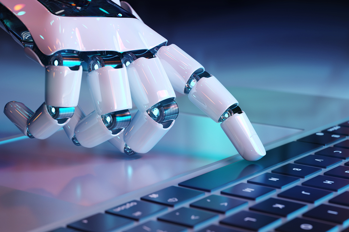 AI robot hand pressing a computer keyboard