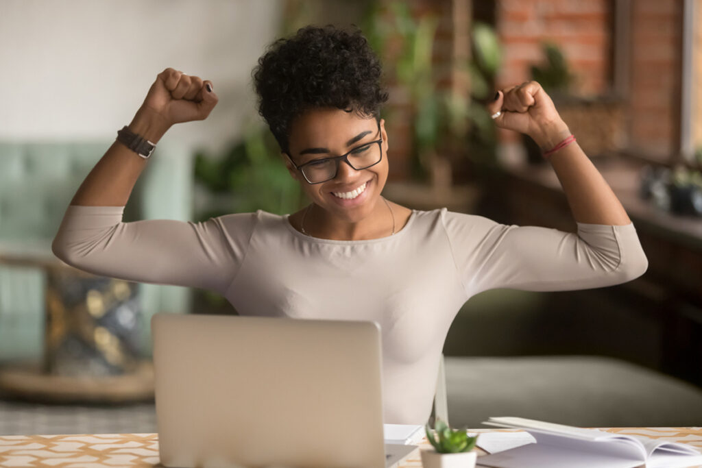 Black woman celebrating being selected in the final round of a project decision