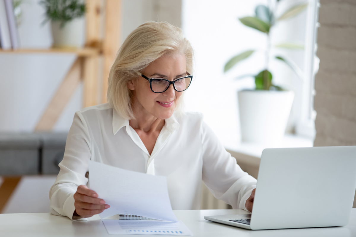 Middle aged white woman working at a computer in an office