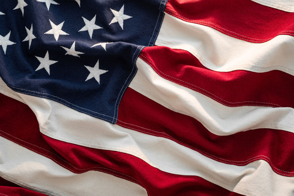 Close-up US Flag American flag waving in sunlight, honoring the meaning of Memorial Day