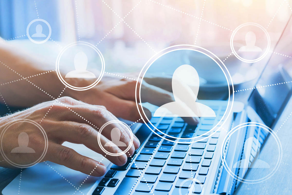 Photo of a person's hands on a keyboard with illustrations of silhouettes on top, representing sending LinkedIn invitations