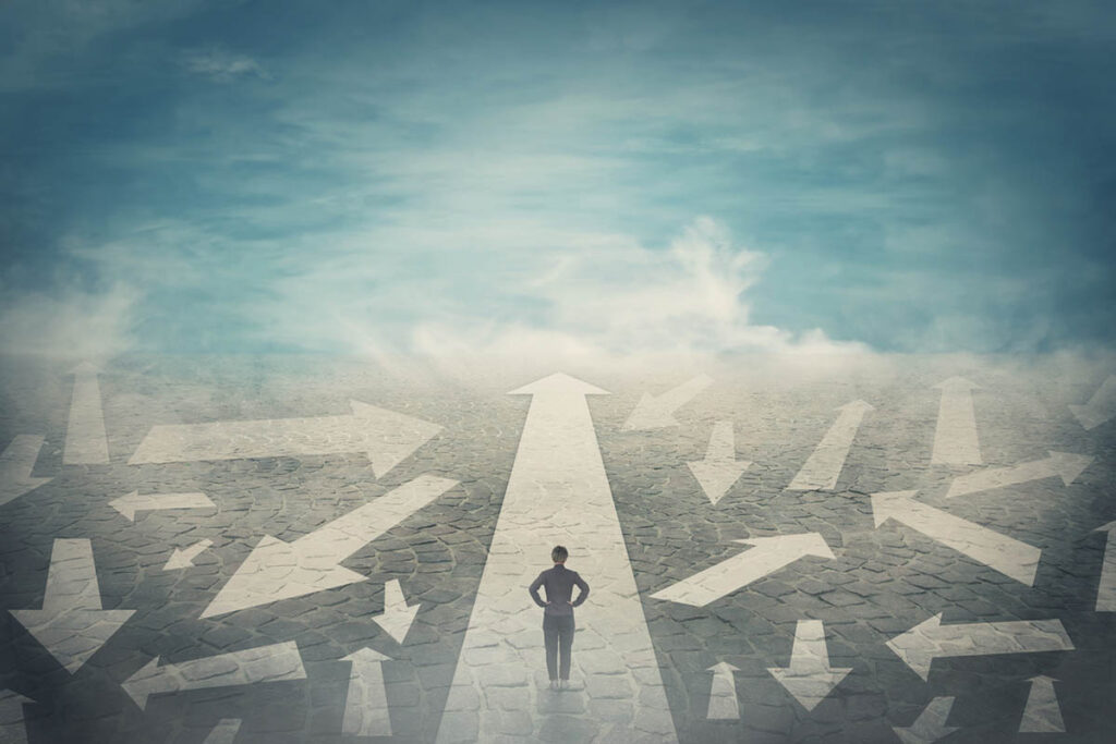 Illustration of person walking on a path with multiple arrows and lifting fog, symbolizing how to navigate uncertainty in business and life.