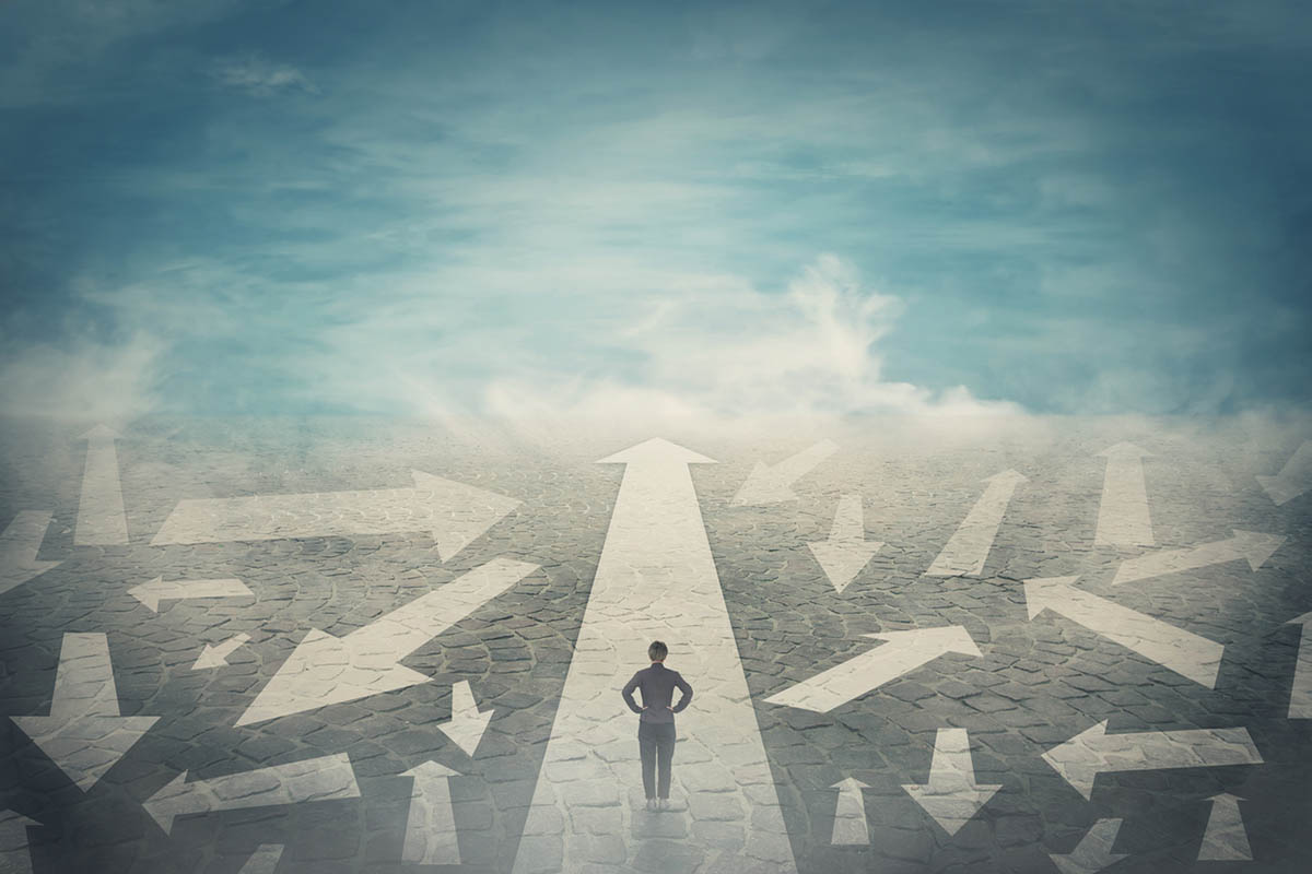Illustration of person walking on a path with multiple arrows and lifting fog, symbolizing how to navigate uncertainty in business and life.