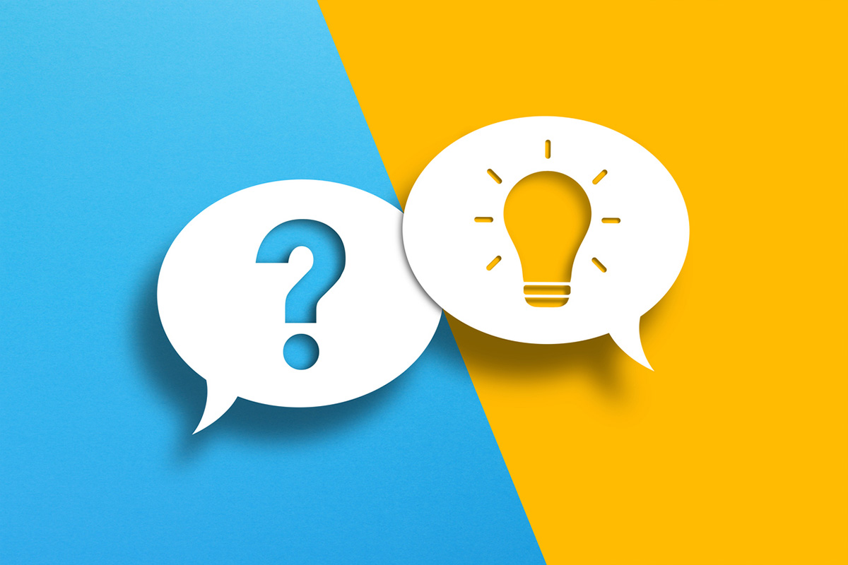 Two overlapping speech bubbles on blue and yellow backgrounds—one with a question mark and one with a lightbulb—symbolizing the process of problem solving and finding solutions.