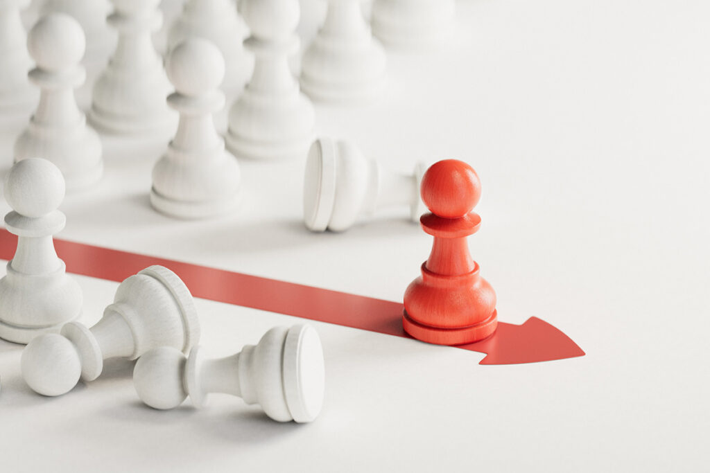 A single red chess pawn moves forward along a red arrow, breaking away from a group of white pawns. The image symbolizes differentiation, bold strategy, and standing out—concepts central to a strong thought leadership strategy.