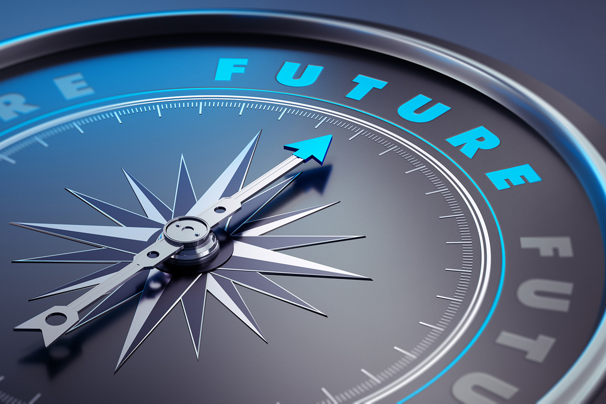 A close-up of a compass pointing toward the word ‘FUTURE’ in bright blue letters, symbolizing direction and insight used when creating trend reports.