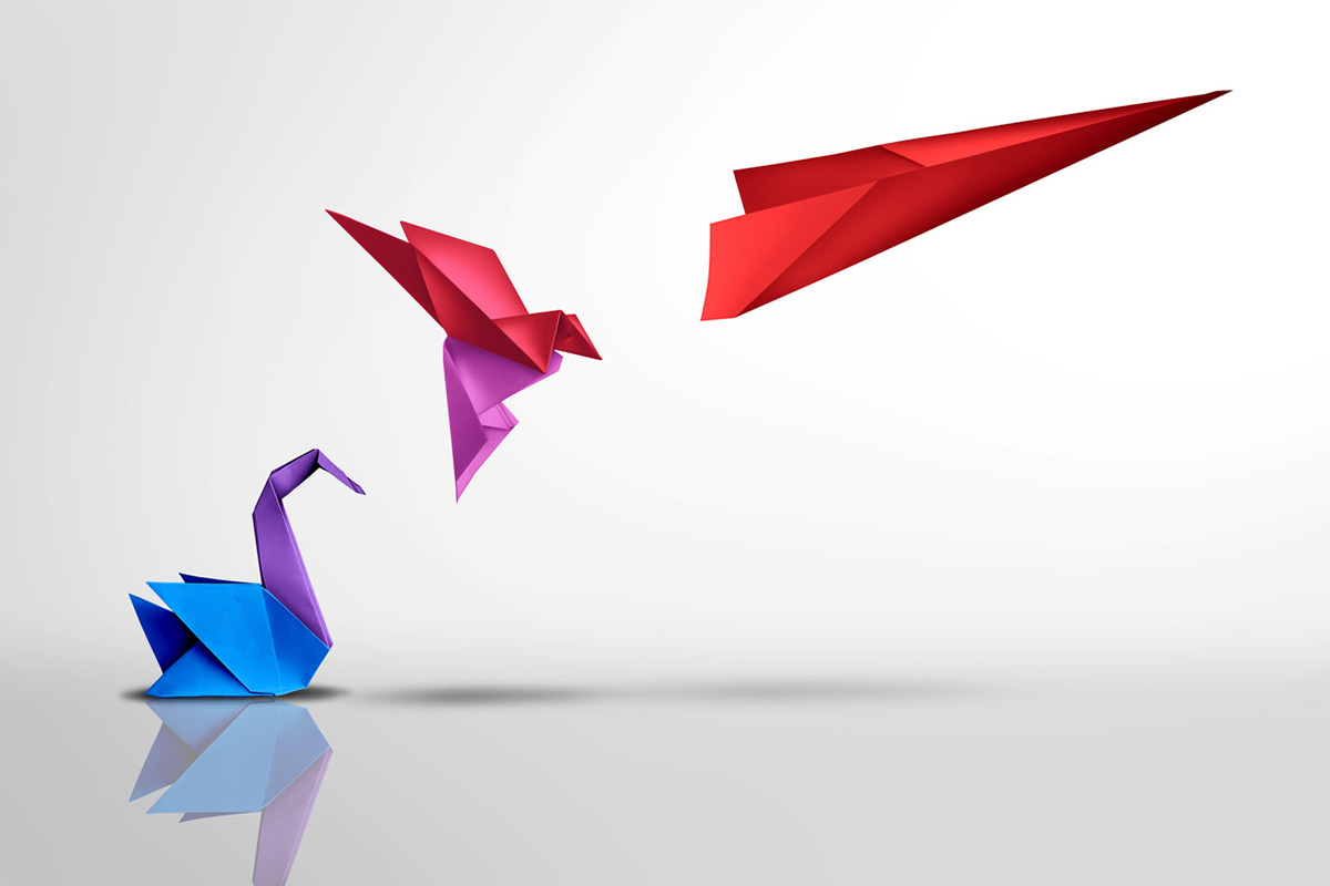 Origami figures transforming from a swan to a bird to a paper airplane, symbolizing professional reinvention and evolving into new forms.