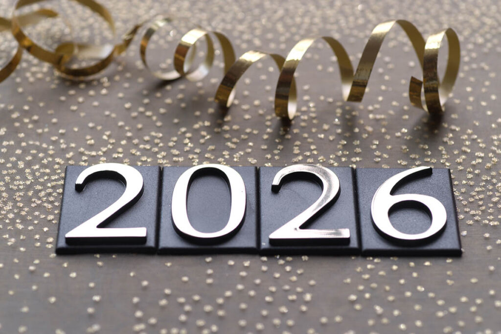 Decorative New Year image showing ‘2026’ with gold ribbon and confetti, representing plans for 2026 and a fresh start.