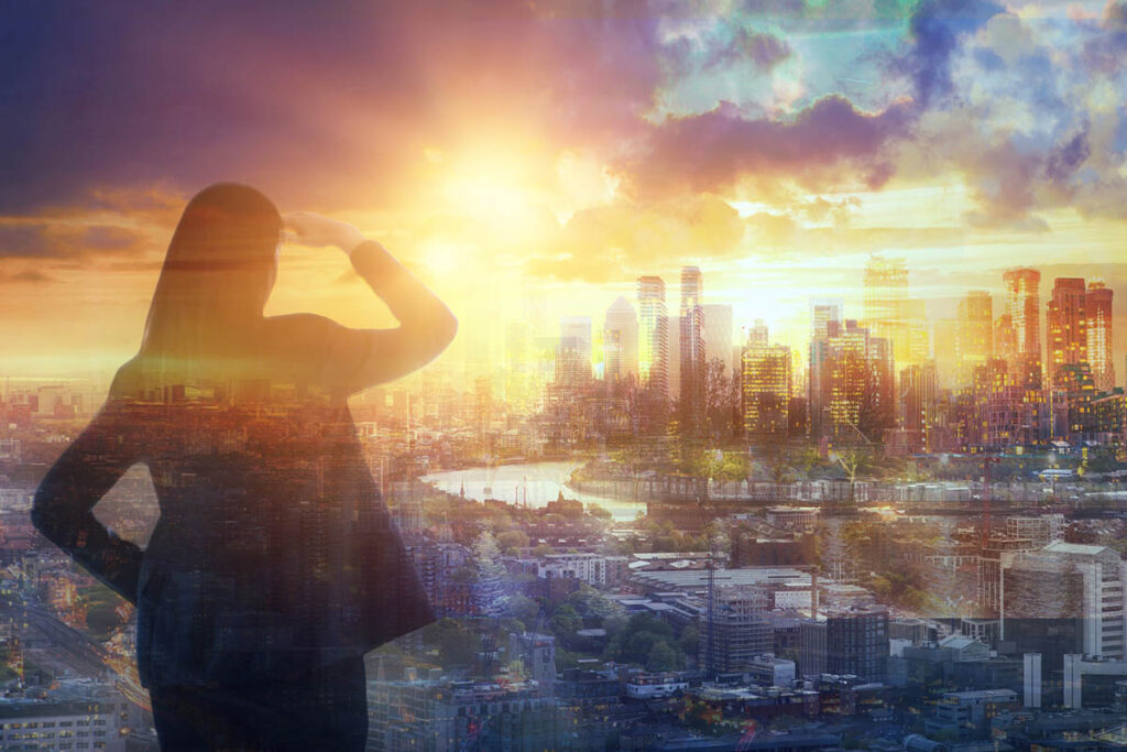 Woman overlooking a city skyline at sunrise, symbolizing perspective and how big picture content marketing helps buyers make sense of change.