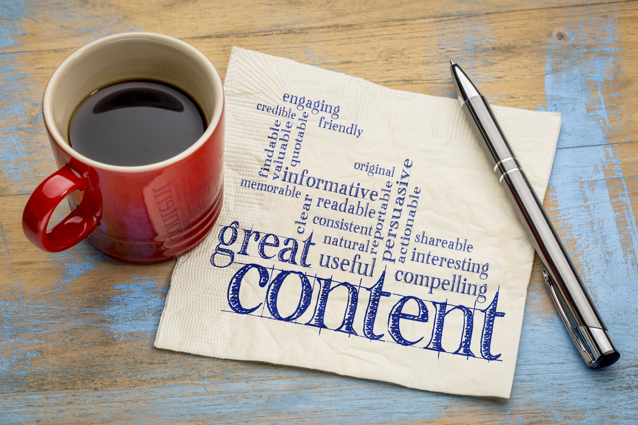 Red mug with napkin that has a word cloud of words about great content and b2b content format