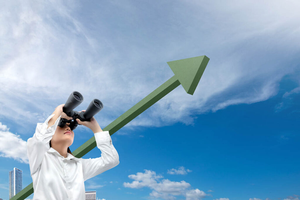 Woman in a white shirt looking through binoculars toward the horizon, with a large upward-pointing arrow in the background symbolizing growth opportunities. The image represents identifying underserved markets and finding business opportunities that others overlook.