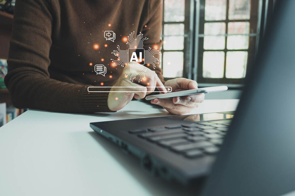 Person using a tablet beside a laptop with digital AI, search, and messaging icons, illustrating how AI visibility influences online discovery and recommendations.