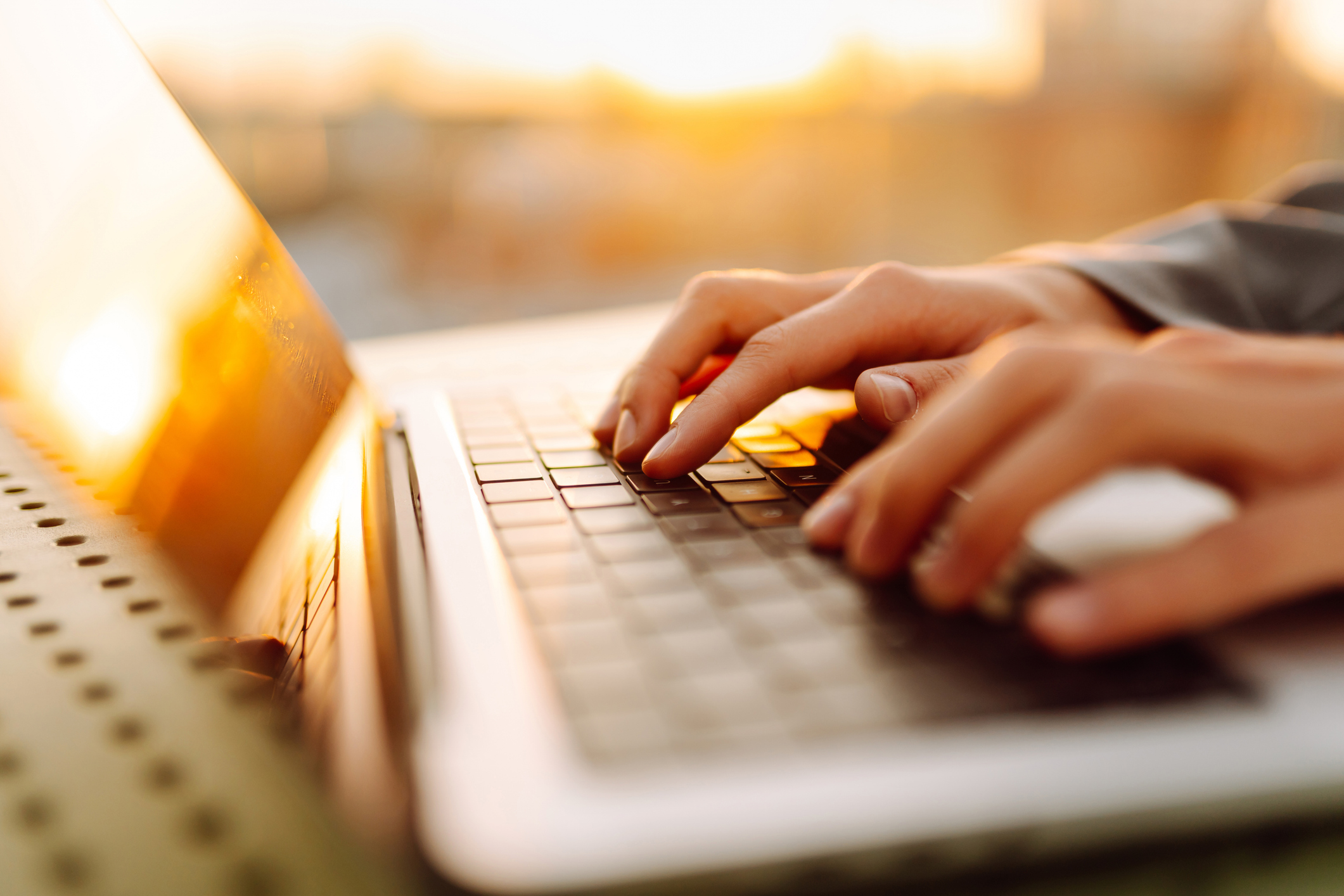Closeup of hands typing on a laptop